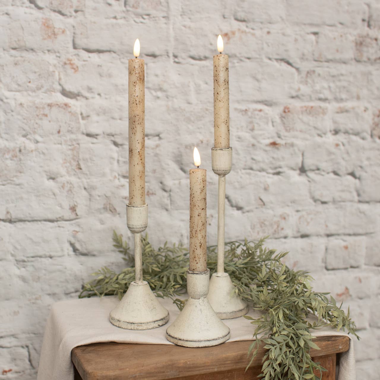 Piri Whitewashed Taper Candleholder, set of 3, on tabletop | Hugo George Home