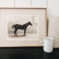 Black horse decor wall art print in gold frame lifestyle image