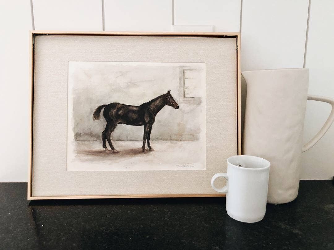 Black horse decor wall art print in gold frame lifestyle image