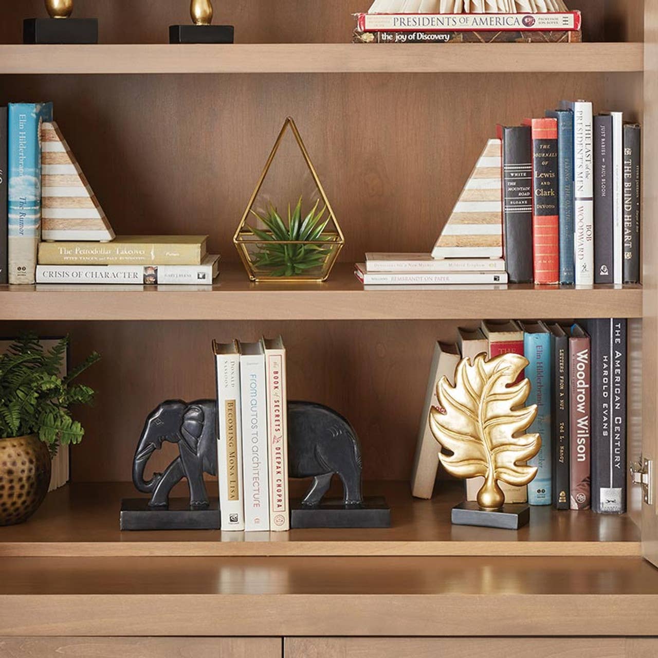 Hagne marble and wood bookends on a bookshelf with books, home decor, and decorative objects