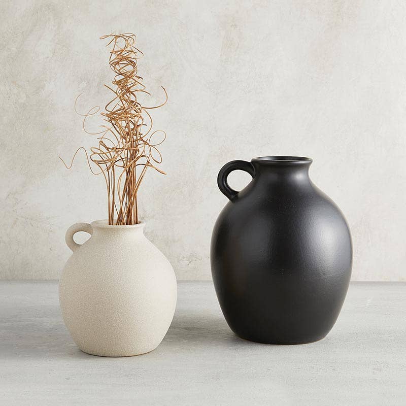 Orban black ceramic vase with handle and smaller white ceramic vase with handle on neutral background | Hugo George Home