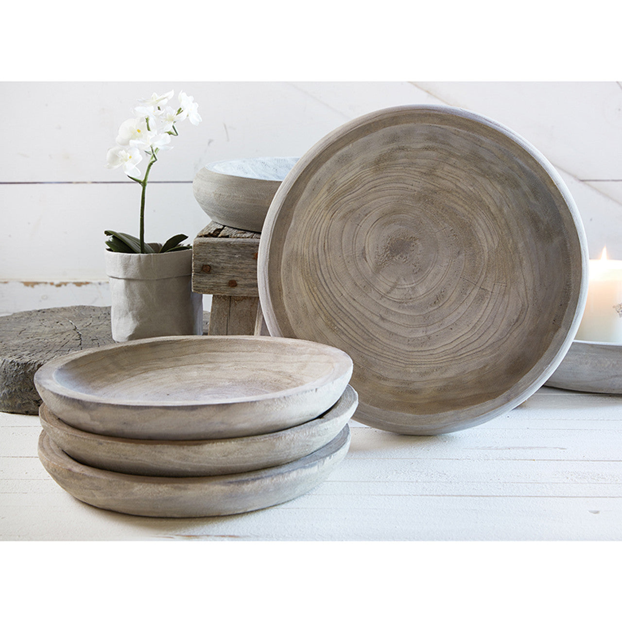 Iren Paulownia Wood Bowls in a counter with flowers in a vase