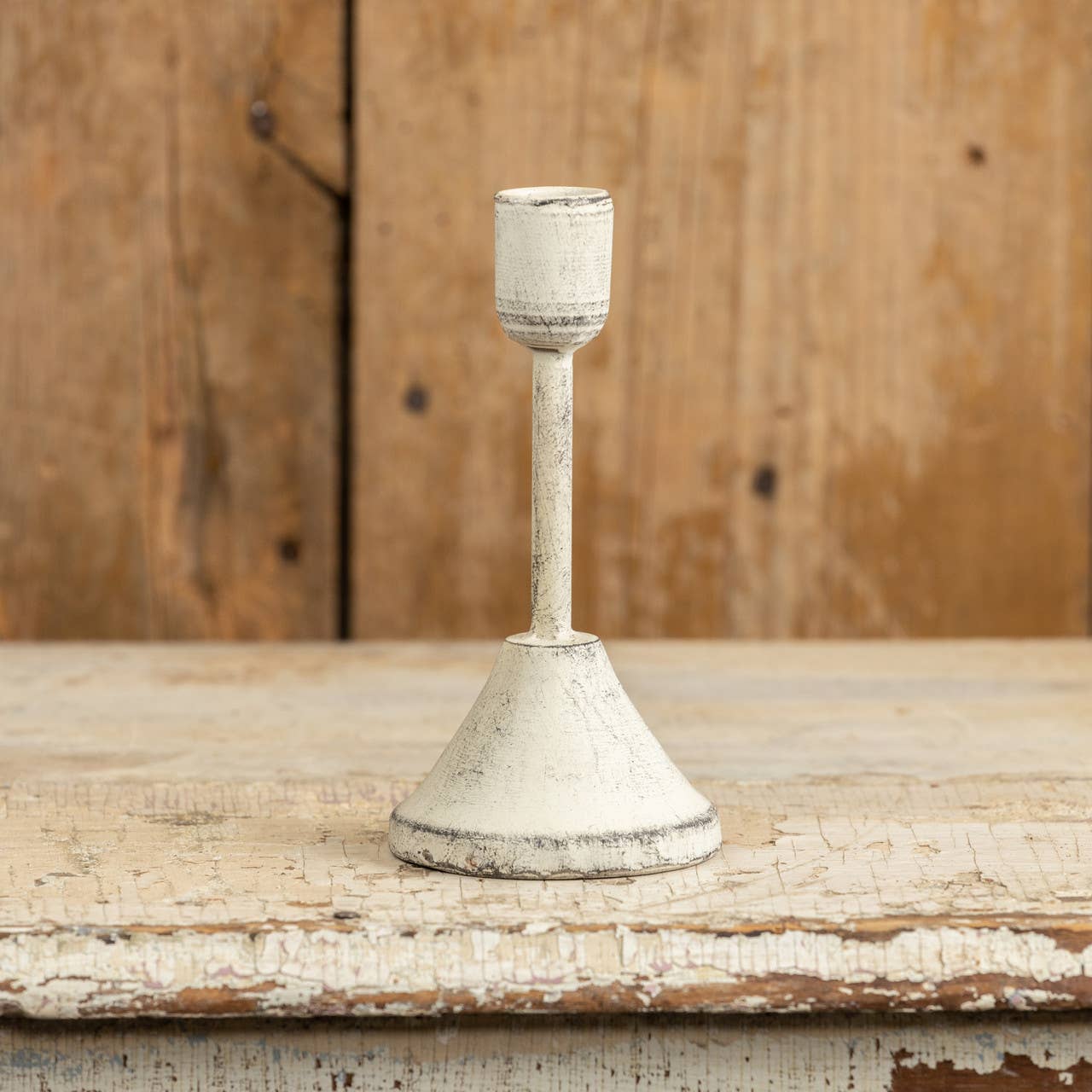 Piri White Distressed Taper Candlestick  on rustic tabletop with wood background | Hugo George Home Decor & Accessories